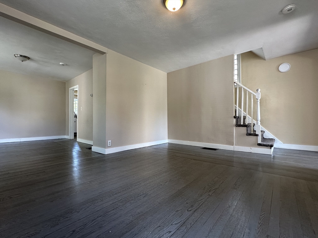 177 Johnson Street Springfield, MA 01108 - Photo 7 of 23 a view of an empty room with wooden floor and a window