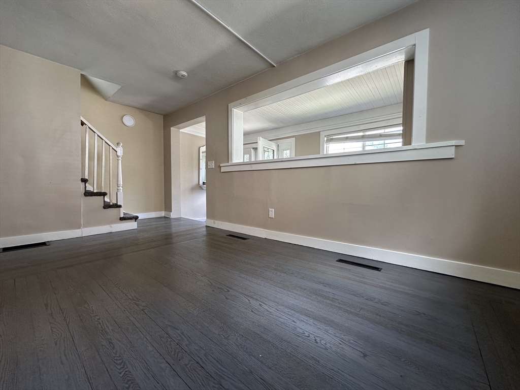 177 Johnson Street Springfield, MA 01108 - Photo 8 of 23 a view of an empty room with wooden floor and a window