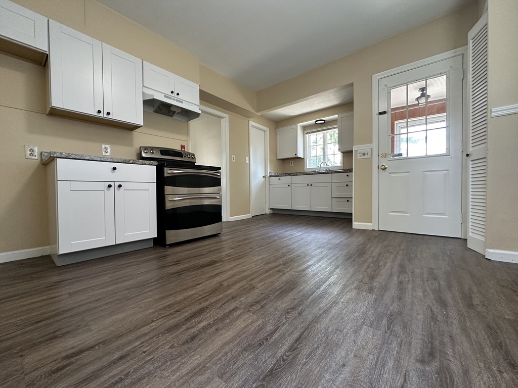 177 Johnson Street Springfield, MA 01108 - Photo 10 of 23 a kitchen with wooden floors and appliances