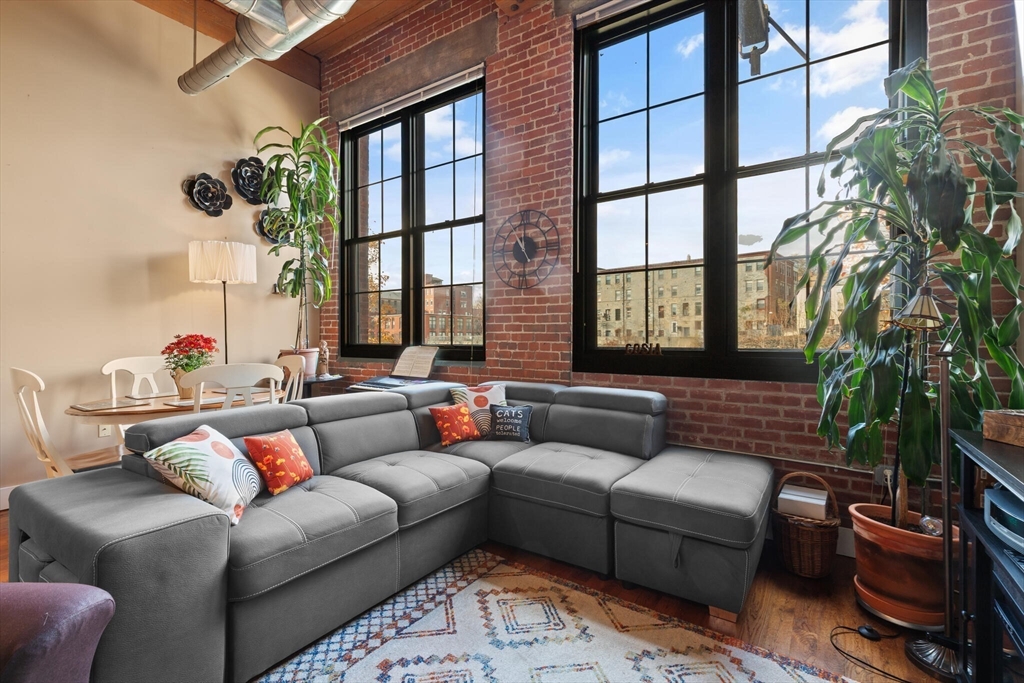 99 Allen Street, Unit 205 Woonsocket, RI 02895 - Photo 15 of 37 a living room with furniture and a window