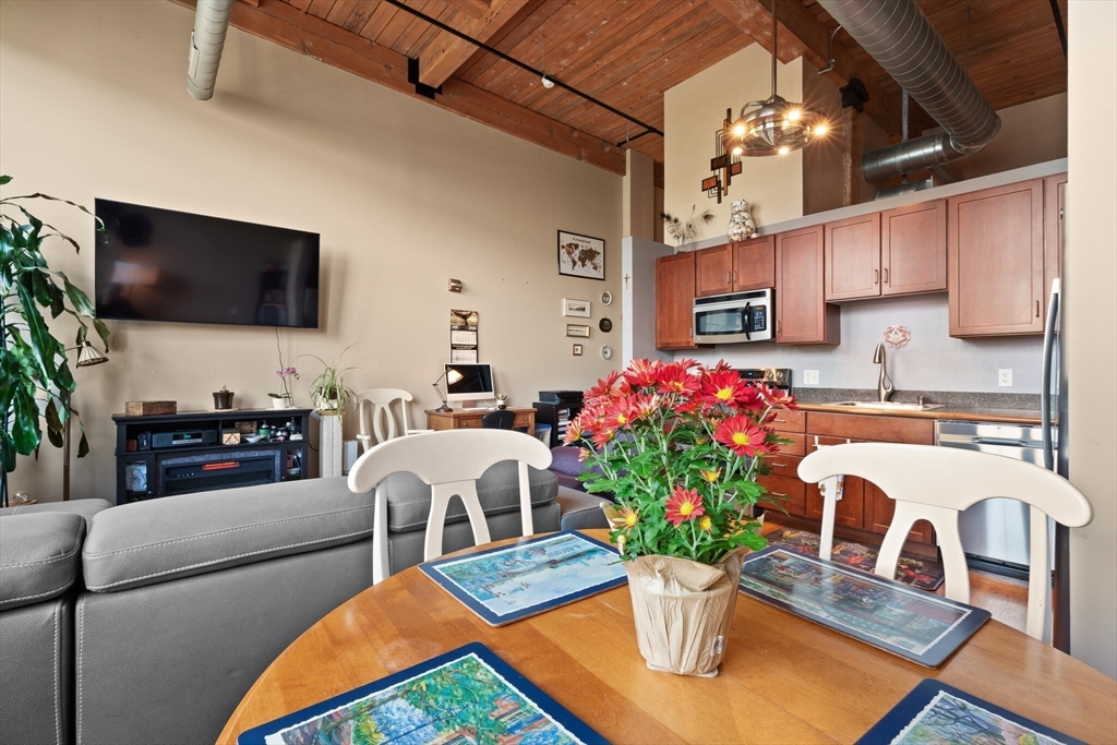 99 Allen Street, Unit 205 Woonsocket, RI 02895 - Photo 17 of 37 a living room with furniture kitchen view and a flat screen tv