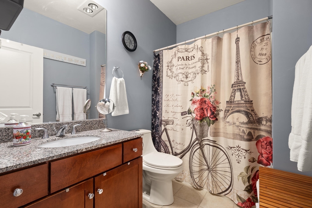 99 Allen Street, Unit 205 Woonsocket, RI 02895 - Photo 29 of 37 a bathroom with a granite countertop sink mirror vanity and toilet