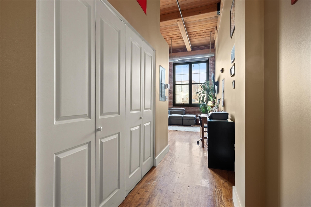 99 Allen Street, Unit 205 Woonsocket, RI 02895 - Photo 10 of 37 a view of a hallway with a dining table chairs