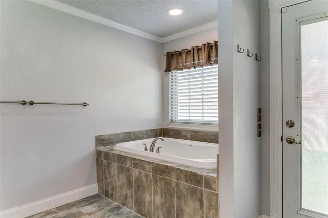 a bathroom with a bathtub and shower