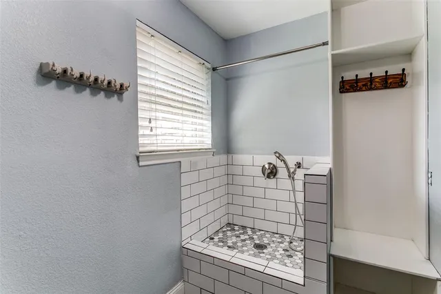 a bathroom with a bathtub and shower