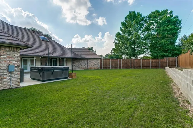 a view of an house with backyard space and balcony