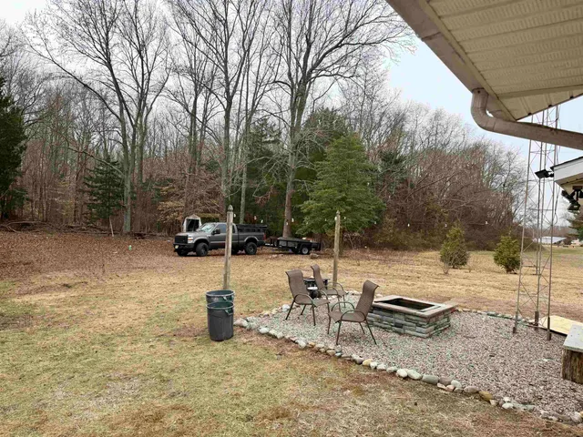 a view of a backyard with chairs