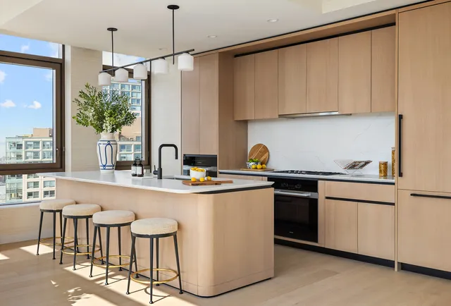 a kitchen with stainless steel appliances granite countertop a sink and a refrigerator