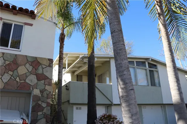 a view of a house with a palm tree