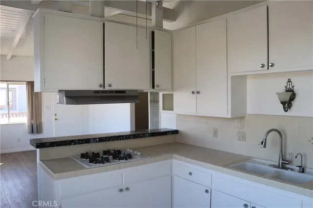a view of a microwave and cabinets