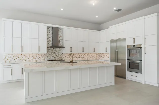 a kitchen with stainless steel appliances a sink and a refrigerator