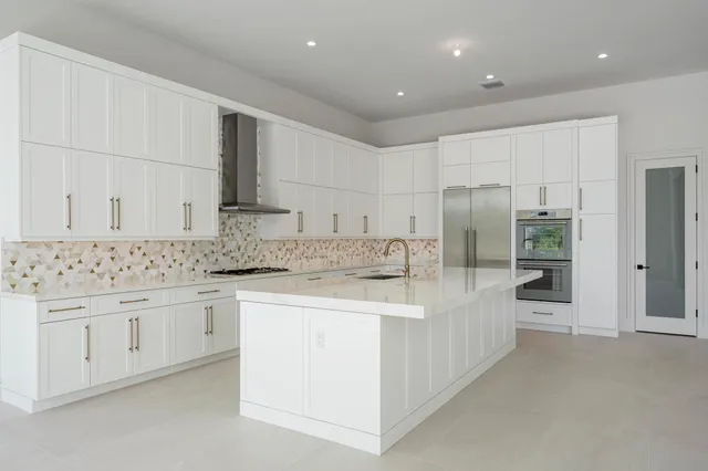 a kitchen with a sink stove and refrigerator