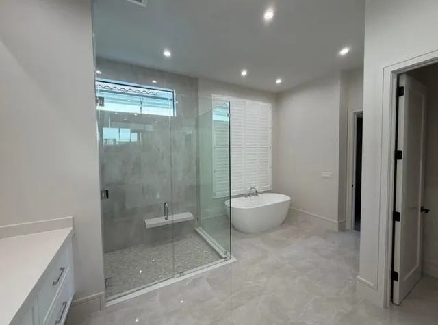 a bathroom with a granite countertop sink a toilet and shower