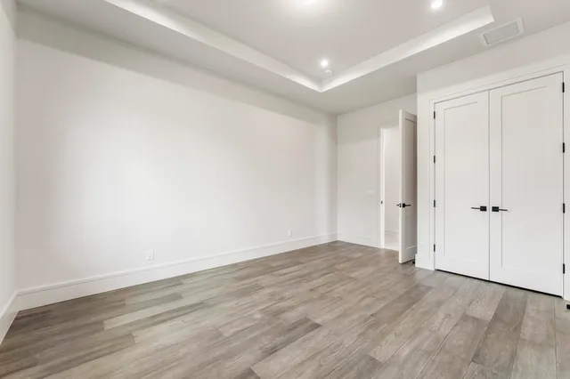 a bathroom with a toilet a sink a glass door a shower and a mirror