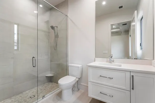 a bathroom with a toilet a sink and a mirror