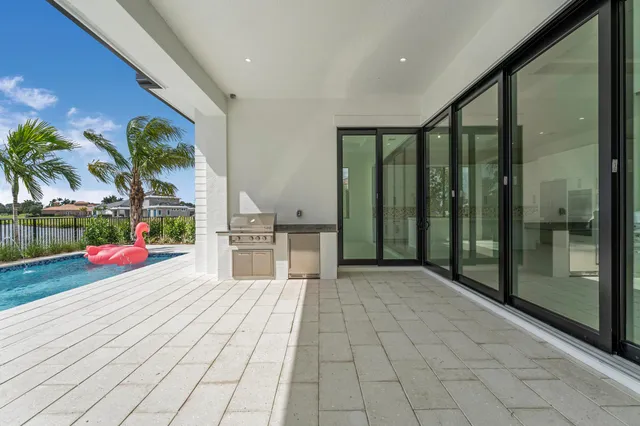 a view of a kitchen with a stove cabinets and a floor to ceiling window