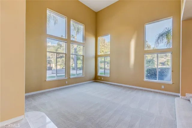 a view of a hallway with wooden floor and a kitchen