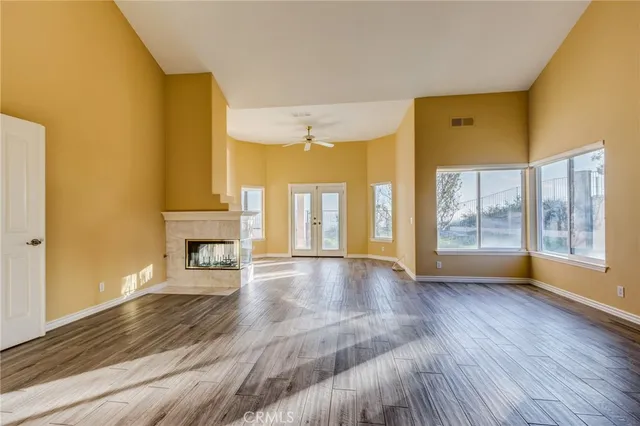 a view of an empty room and wooden floor