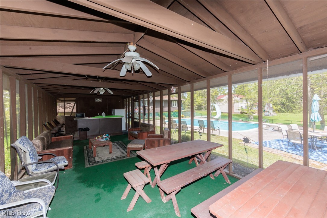 2170 Norton Road Stow, OH 44224 - Photo 15 of 48 Expansive screened-in porch with multiple ceiling fans and a built-in bar area