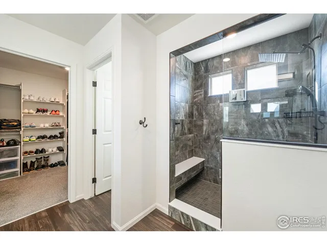 a view of a hallway with cabinet and floor to ceiling window