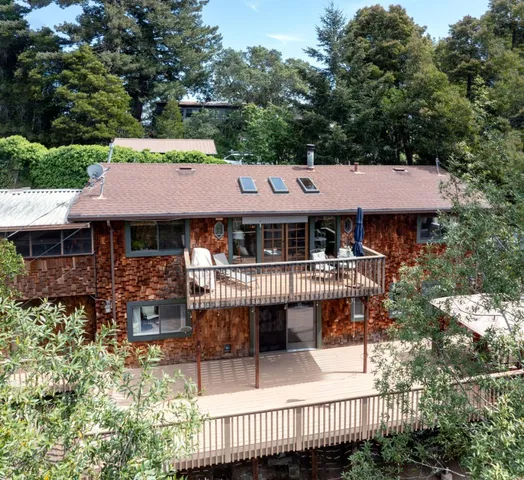 an aerial view of a house with swimming pool and sitting area