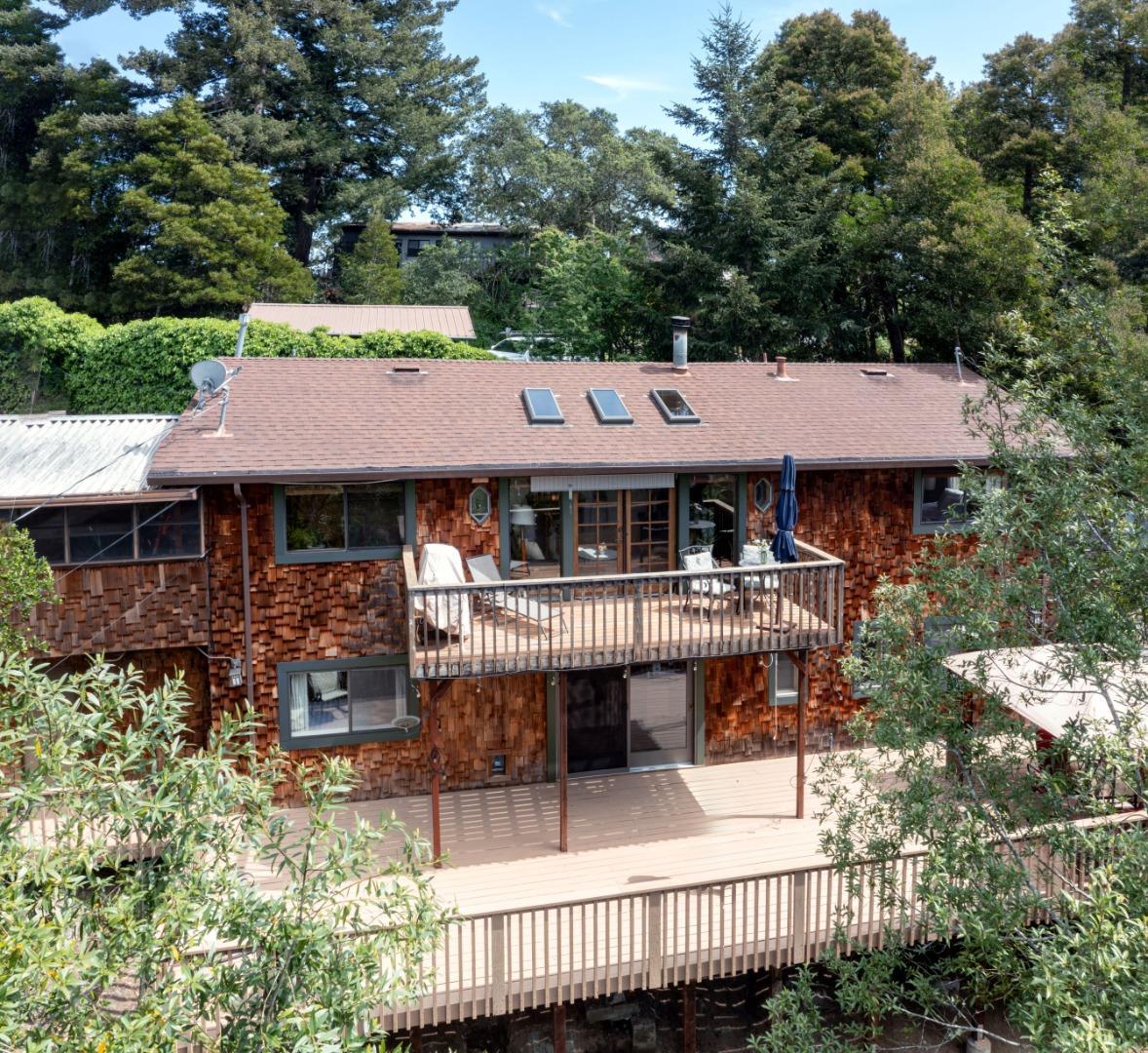 an aerial view of a house with swimming pool and sitting area