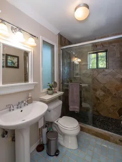 a bathroom with a toilet sink and mirror