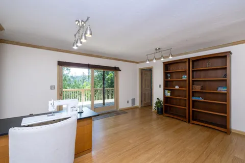 a living room with furniture and large windows