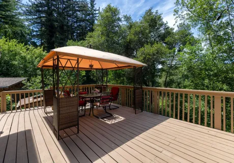 a view of balcony with outdoor seating and wooden floor