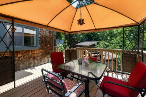 a view of city from a balcony with furniture