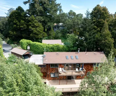 an aerial view of a house with swimming pool and garden