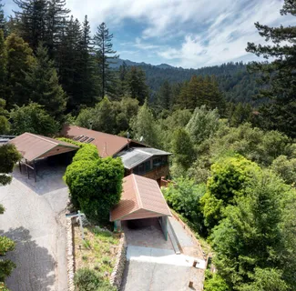 an aerial view of a house with yard