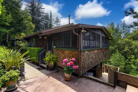 a view of house with outdoor space and trees around