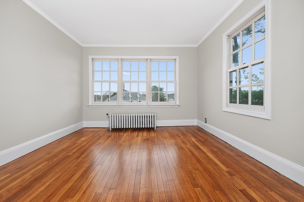 18 Bennett Street, Unit 2 Manchester, MA 01944 - Photo 18 of 21 an empty room with wooden floor and windows