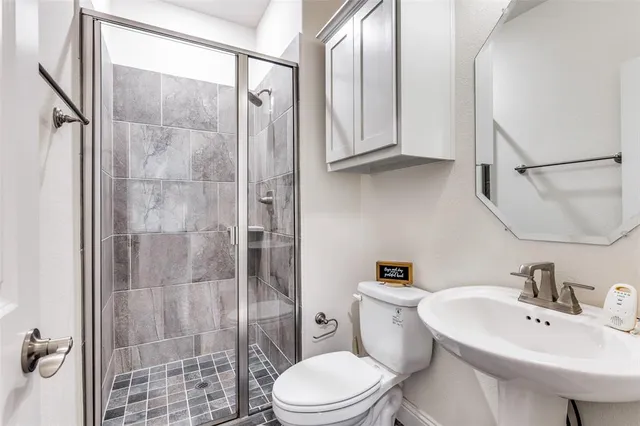 a bathroom with a toilet and a shower