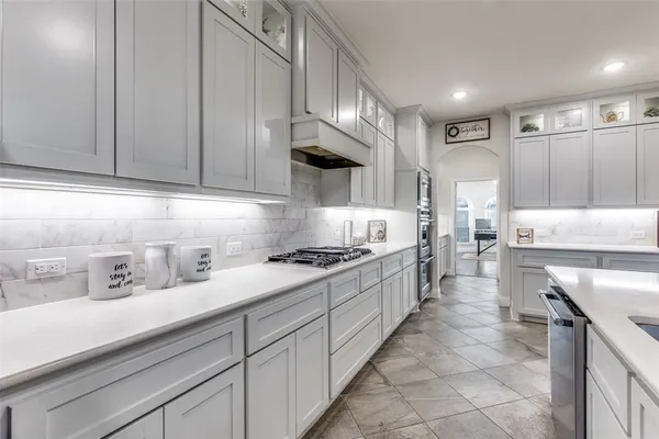 a living room with furniture ceiling fan and a wooden floor