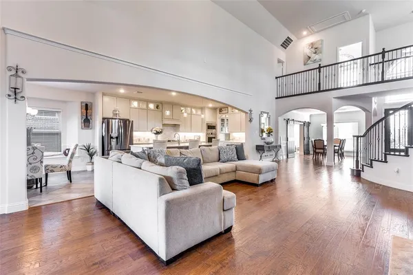 a living room with furniture a window and a chandelier