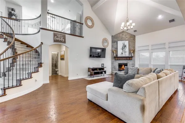a living room with furniture and a chandelier
