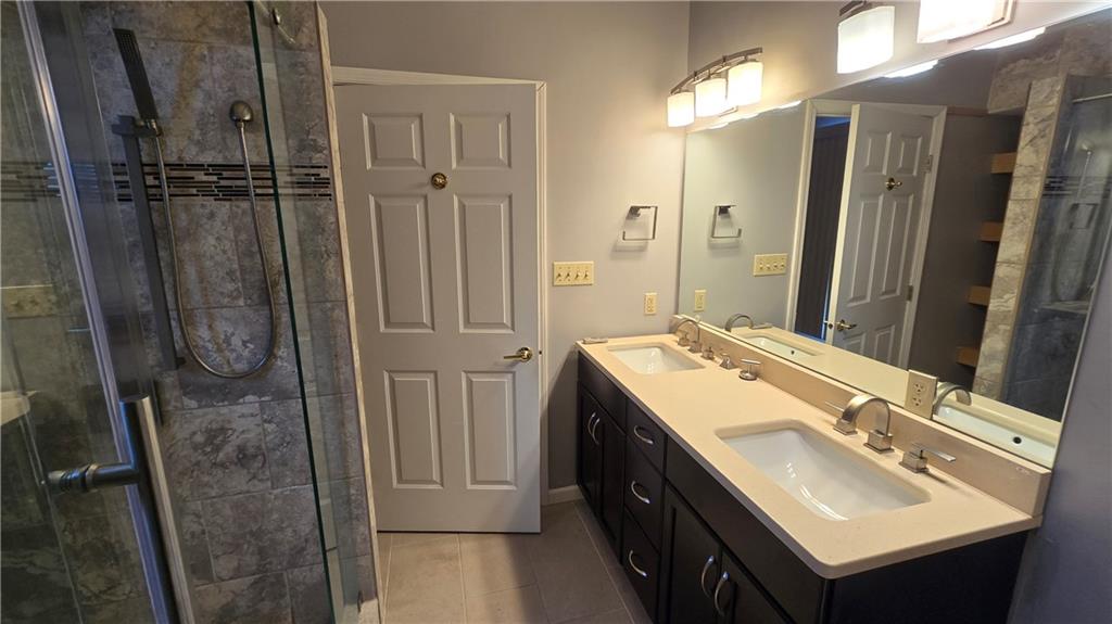 243 Augusta Street Pittsburgh, PA 15211 - Photo 19 of 43 a bathroom with a sink a mirror and a shower