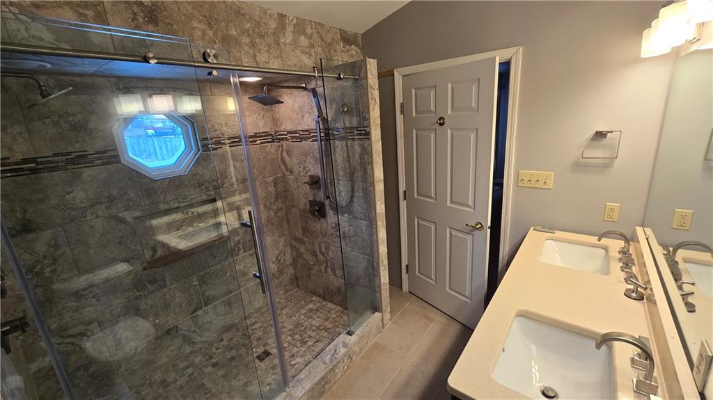 243 Augusta Street Pittsburgh, PA 15211 - Photo 23 of 43 a bathroom with a sink and glass door shower