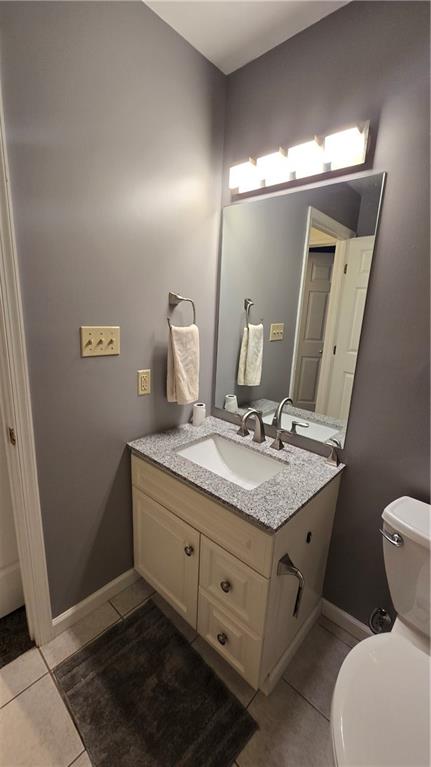 243 Augusta Street Pittsburgh, PA 15211 - Photo 32 of 43 a bathroom with a granite countertop sink a toilet and mirror