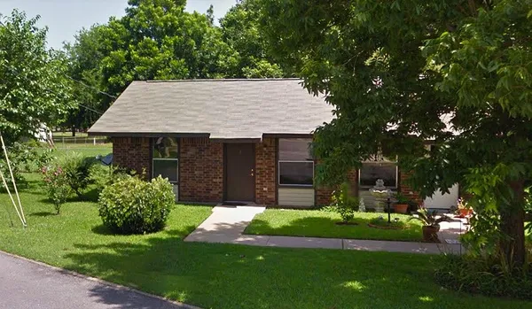 a front view of house with a garden