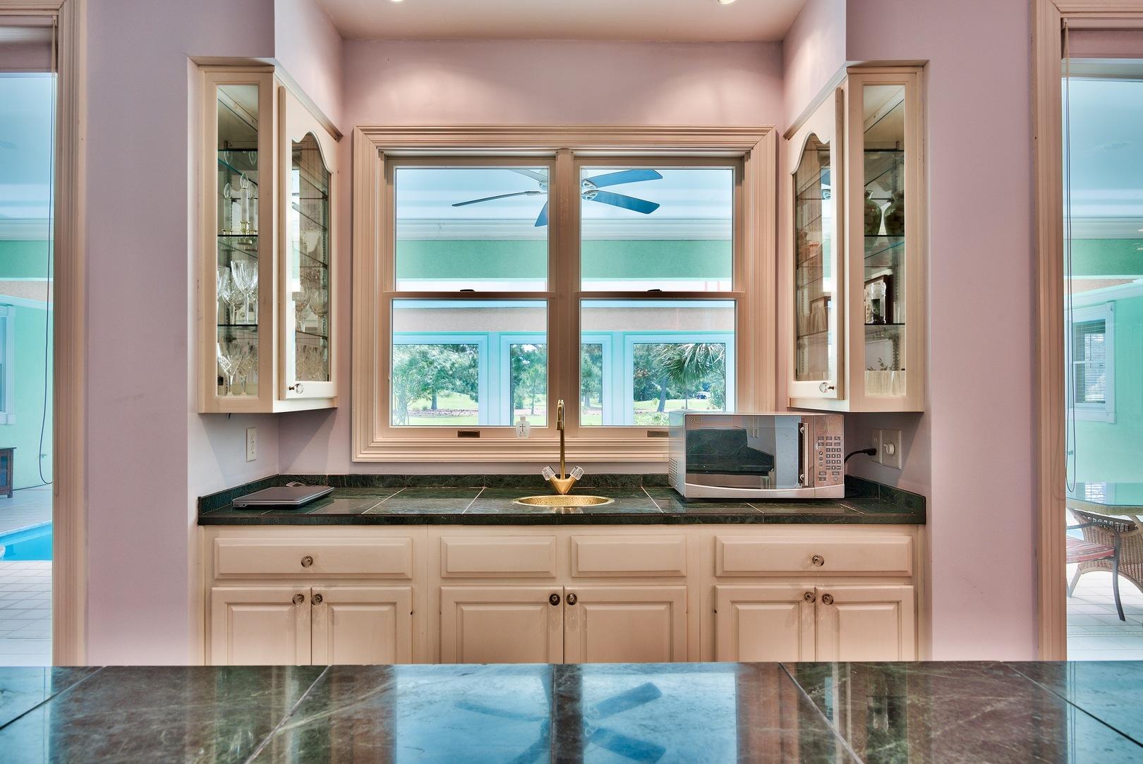 8 Weekewachee Circle Destin, FL 32541 - Photo 10 of 26 a kitchen with granite countertop a sink and a window