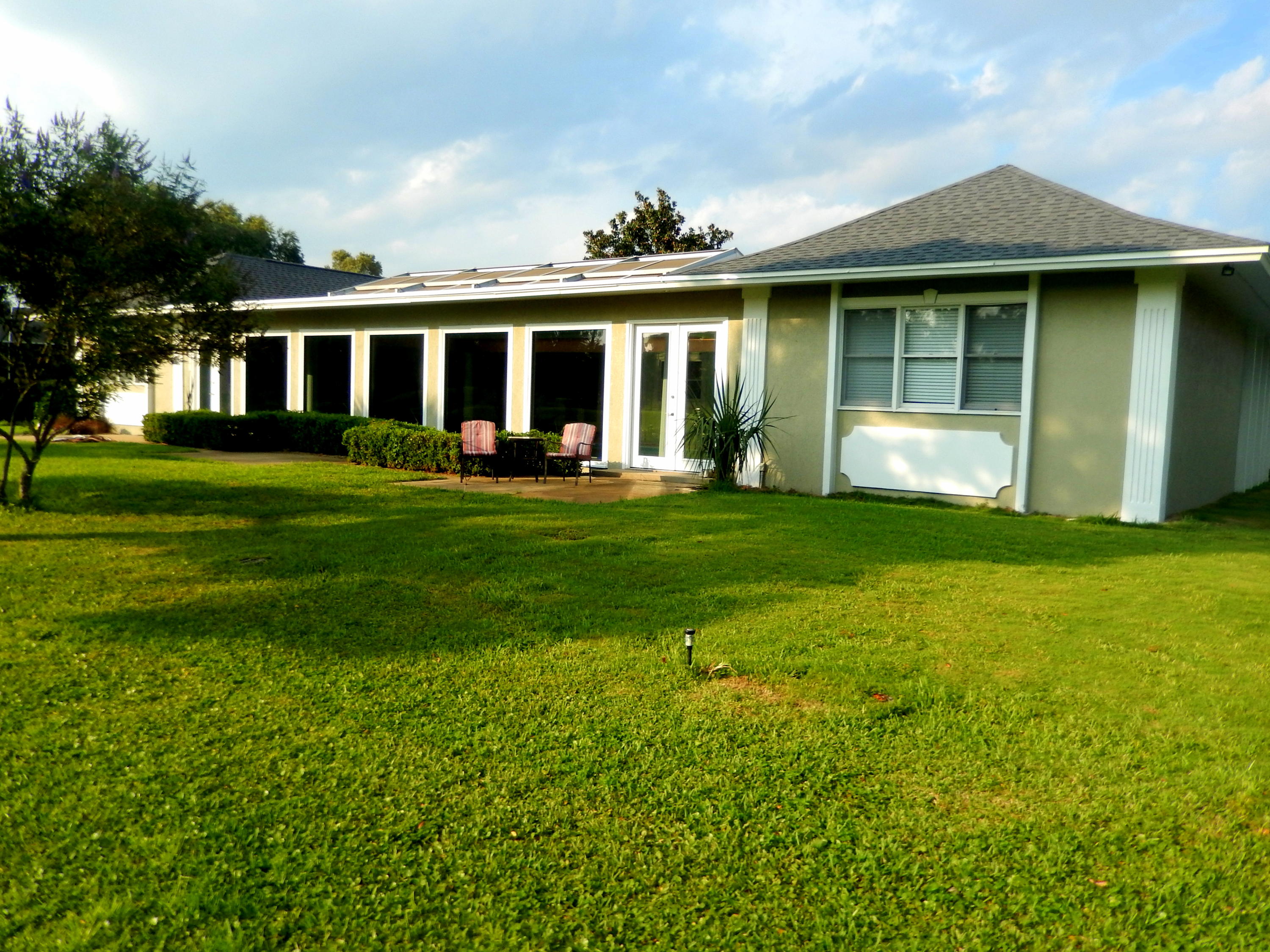 8 Weekewachee Circle Destin, FL 32541 - Photo 22 of 26 a front view of a house with a garden and porch
