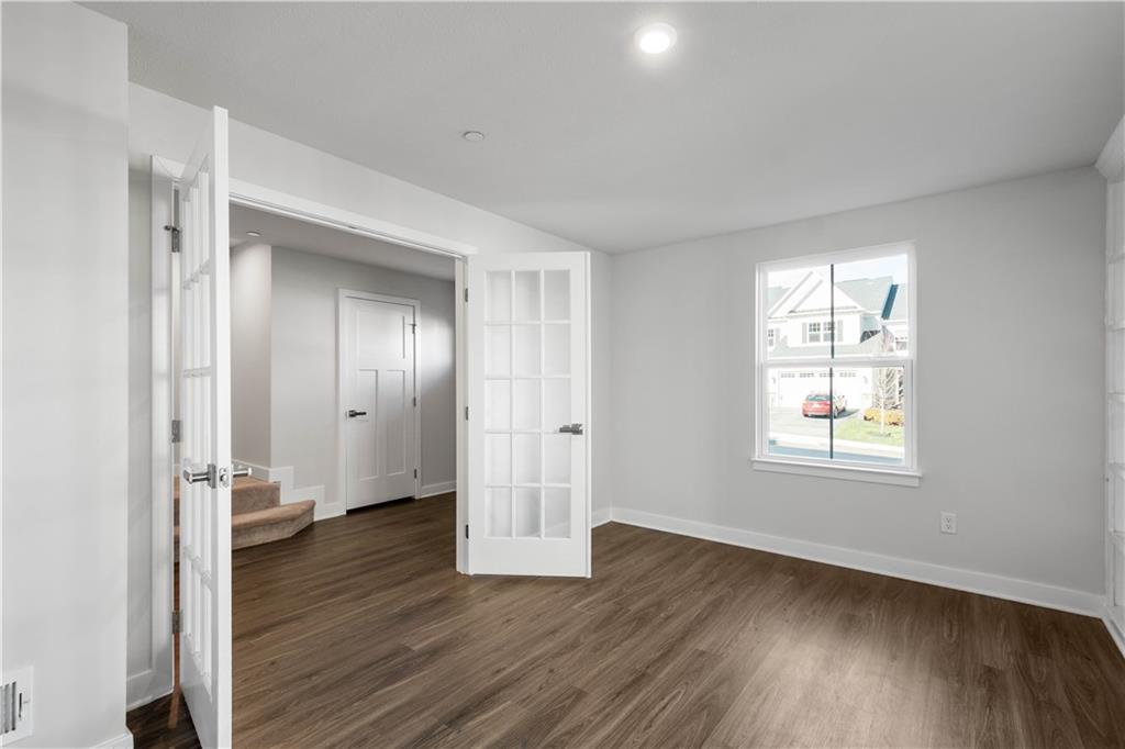 4108 Spruce Road Gibsonia, PA 15044 - Photo 4 of 46 an empty room with wooden floor and windows