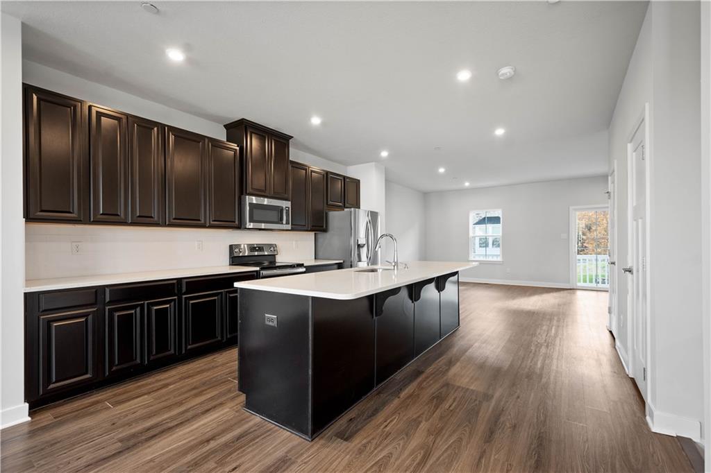 4108 Spruce Road Gibsonia, PA 15044 - Photo 8 of 45 a large kitchen with stainless steel appliances wooden cabinets and a wooden floor