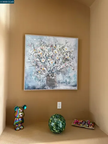 a living room with stainless steel appliances kitchen island granite countertop a table chairs and a view of living room