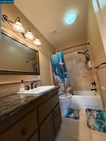 a bathroom with a large tub and sink
