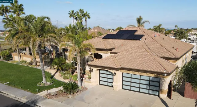 an aerial view of a house with a yard