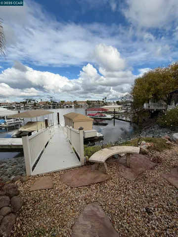a view of roof deck with wooden floor and fence